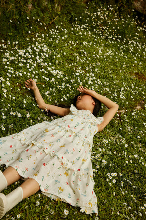 Campaign photo of the Chisa Tiered Smocked Maxi Dress with Ruffle Sleeves for kids from the Spring Summer collection of Filipino kids fashion brand Gingersnaps Philippines, featuring a smocked bodice, ruffle sleeves, and a flowing tiered silhouette.