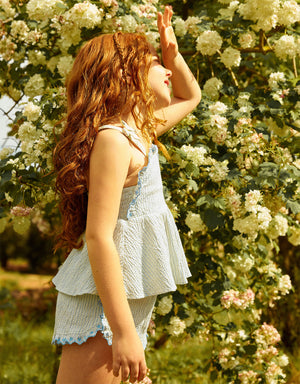 Campaign photo of the Isabel Ruffled Striped Apron Top with Tie Straps & Ruffled Shorts set for kids from the Spring Summer collection of Filipino kids fashion brand Gingersnaps Philippines.