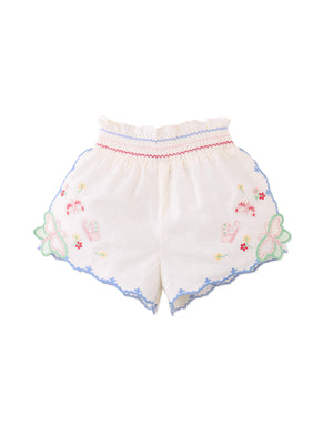 Campaign photo of the Baby Gabrielle Eyelet Dress with Crochet Butterfly Appliqué for infant girls from the Spring Summer collection of Filipino kids fashion brand Gingersnaps Philippines, featuring eyelet fabric and a crochet butterfly detail.