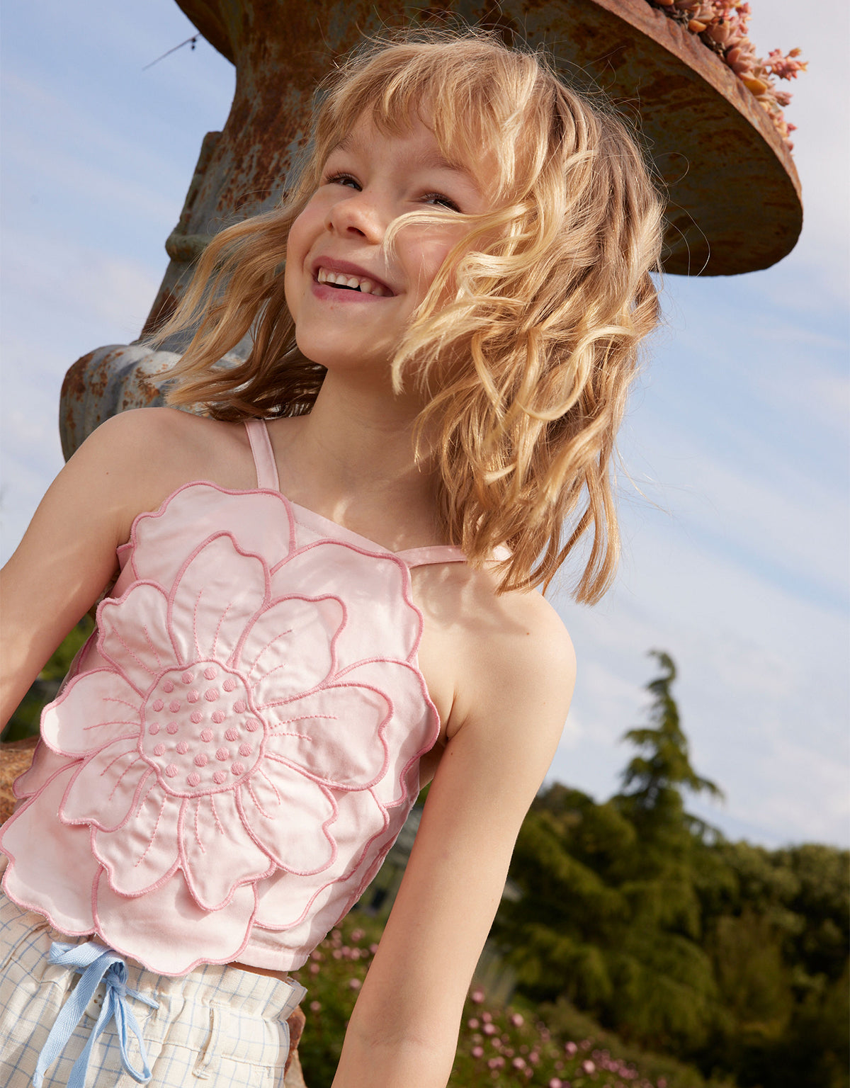 Campaign photo of the Eloise Halter Top in Pink with Large Flower Appliqué & Contrast Stitching for kids from the Spring Summer collection of Filipino kids fashion brand Gingersnaps Philippines, featuring a bold floral appliqué and halter silhouette.