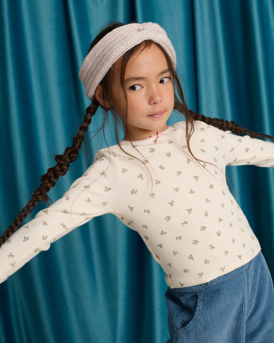 Drusilla Tee with Ruffled Shoulders and Cross-Stitched Flower Appliqué with Lace Trims
