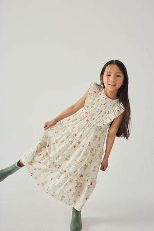 Flatlay front view of the Chisa Tiered Smocked Maxi Dress with Ruffle Sleeves, showcasing the smocked top and tiered skirt details from the Spring Summer collection of Filipino kids fashion brand Gingersnaps Philippines.