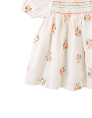 Flatlay front view of the Baby Gigi Embroidered Dress with Puff Sleeves with embroidery and smocked construction from the Spring Summer collection of Filipino kids fashion brand Gingersnaps Philippines.